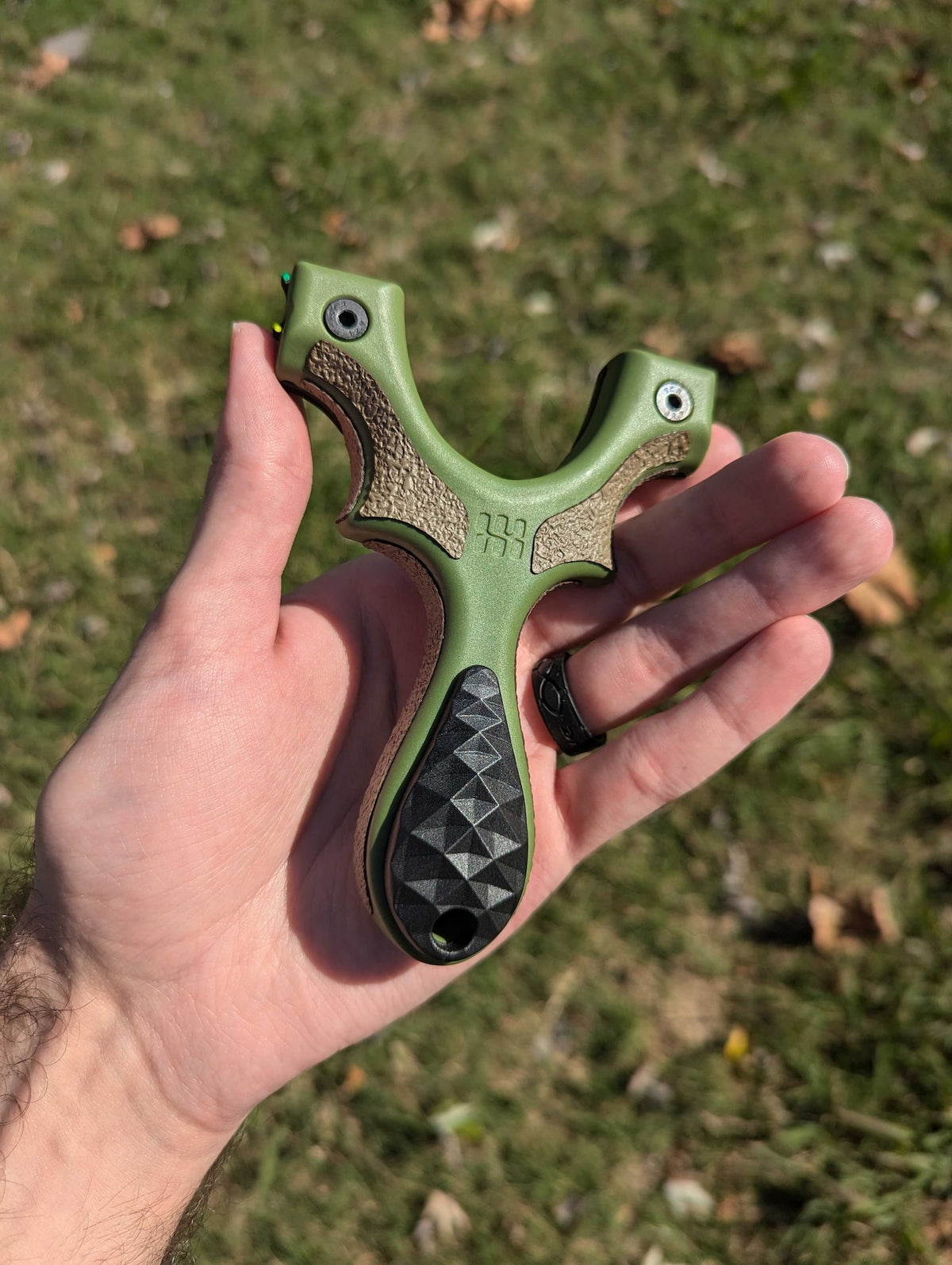 Custom-Cut grips on a slingshot in hand