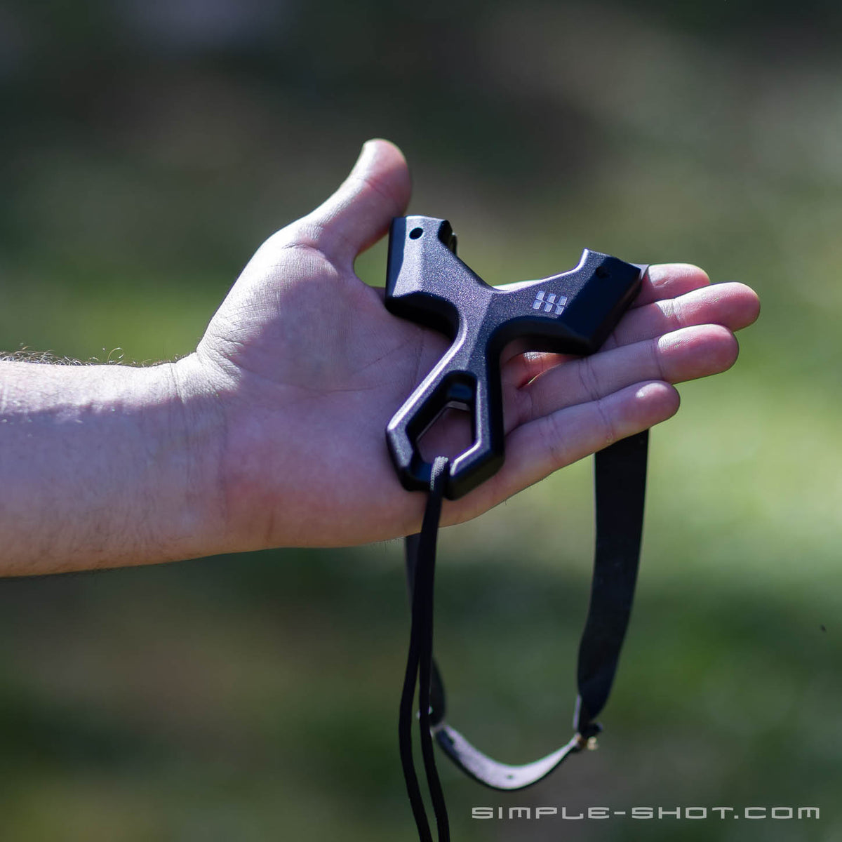 Slant Press PRO resting in an open palm outdoors