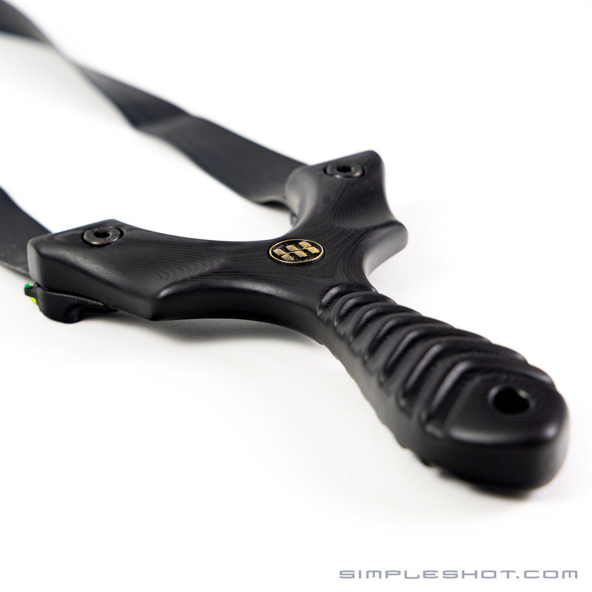 Axiom Carbon Fiber slingshot lying on its side with bands