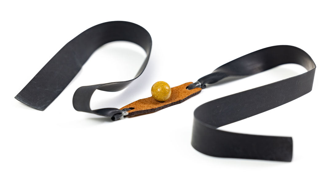 A clay shooting flat band cradling a clay ball