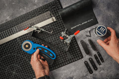 Cutting a slingshot bandset from a sheet of SimpleShot Black Premium Latex with a rotary cutter, taper ruler, and band tying jig