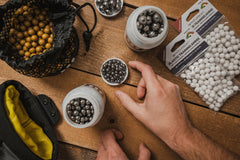 An assortment of slingshot ammo types including steel and clay balls