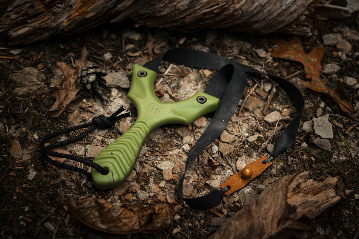 Axiom slim slingshot held in hand, everyday carry