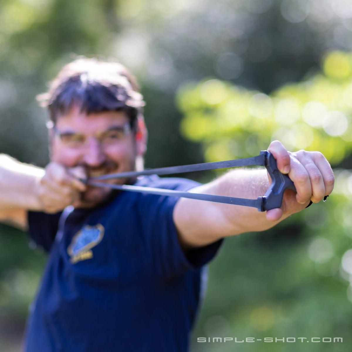 Shooter grinning at full draw with the Slant Roller outdoors