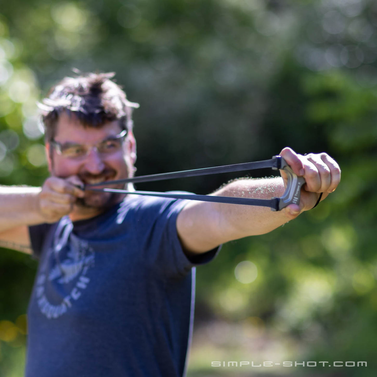 Shooter grinning at full draw with the Torque X PRO outdoors