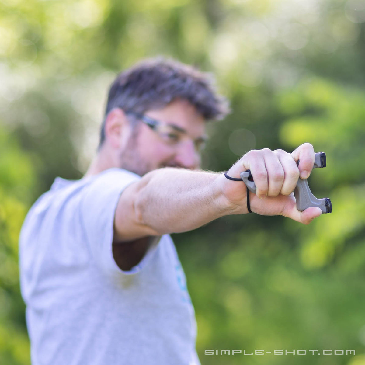 Shooter drawing the Torque X slingshot outdoors