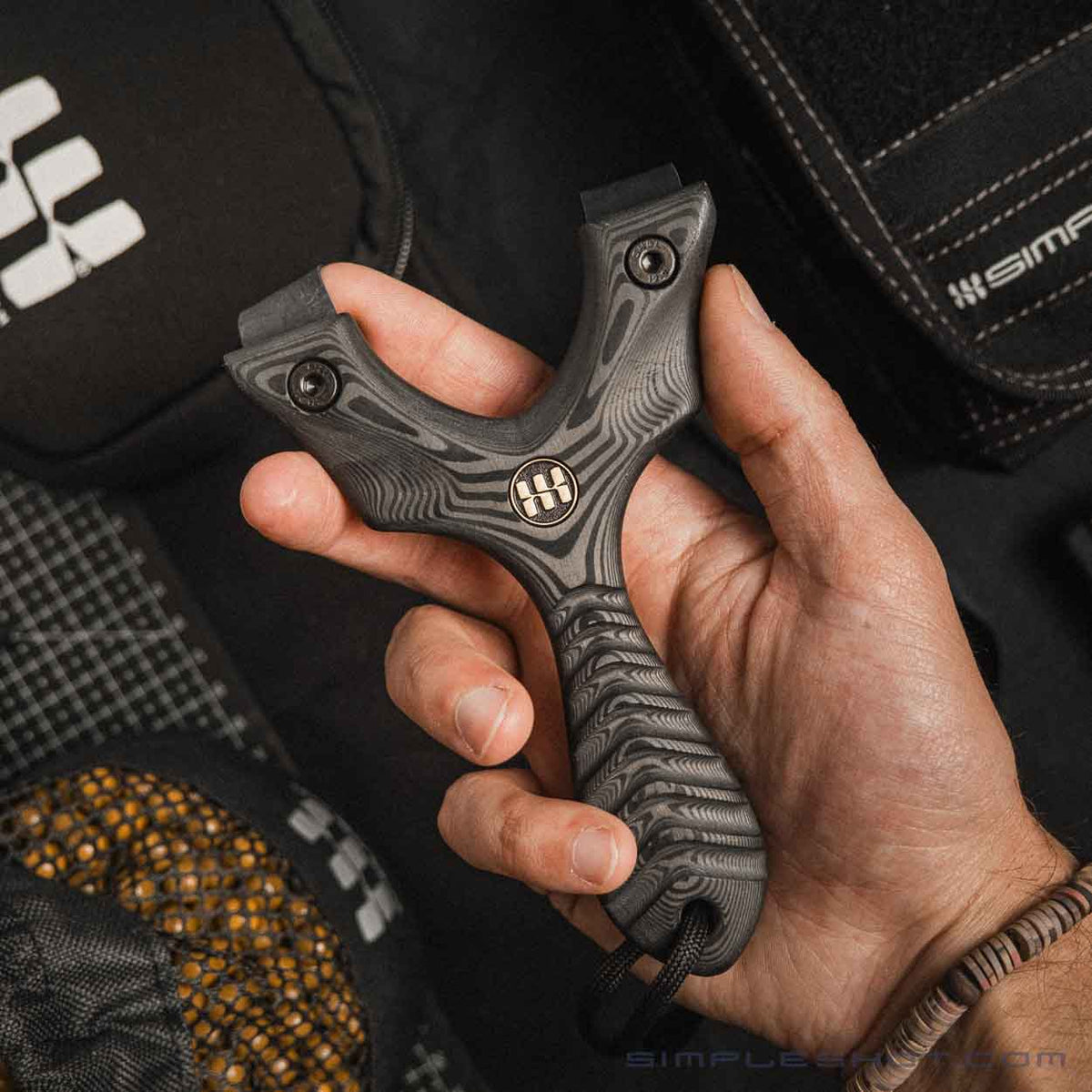 Axiom Carbon Fiber slingshot held in hand