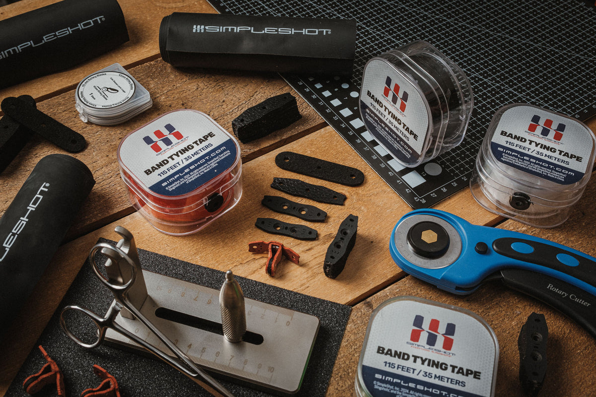 Band tying tape in black, clear, red, and green on the workbench