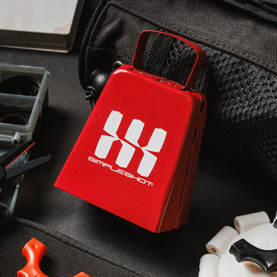 SimpleShot red Cowbell slingshot target in a gear bag