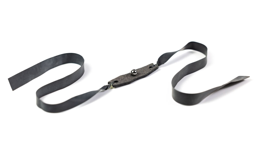 Lite 1/4-inch flat band cradling a small steel ball