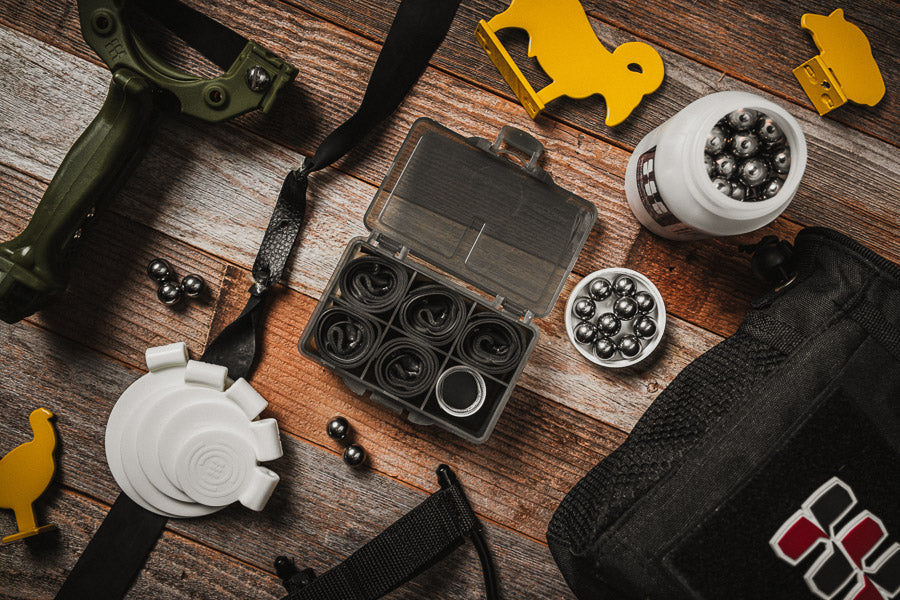 Nitro 1/2-inch flat bands flat-lay with slingshot and large steel ammo