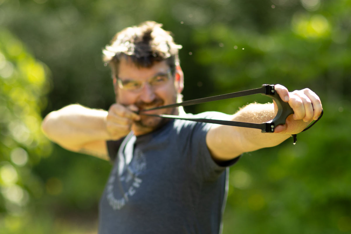 Shooter at full draw with the Scout XT slingshot outdoors