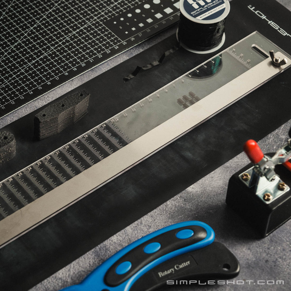 Adjustable Taper Template on a cutting mat beside a rotary cutter and band tying jig