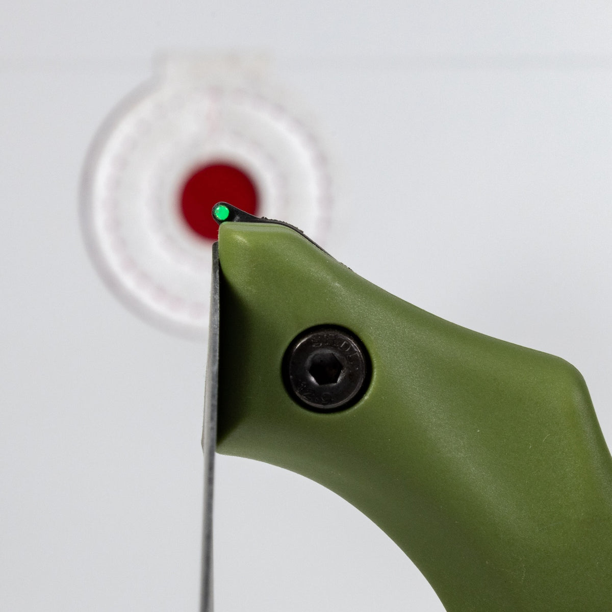 Axiom slingshot fork tip in green lined up on a target, close-up