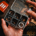 Clay Shooting Flat Bands in an open storage box held in hand