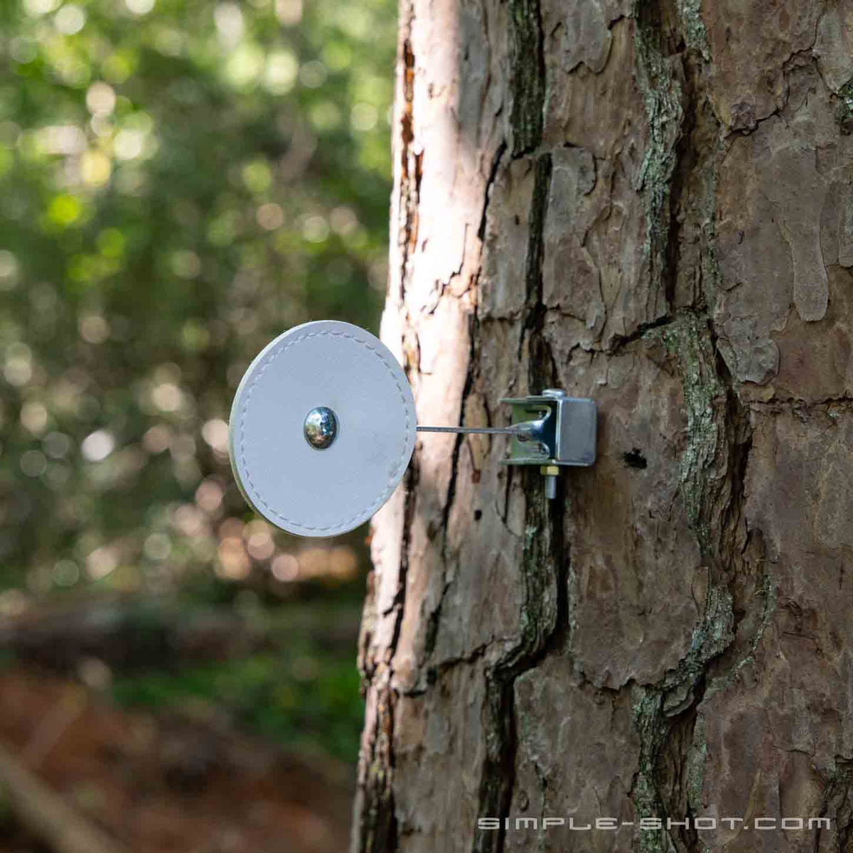Self-Resetting Knockdown Target mounted on a tree trunk