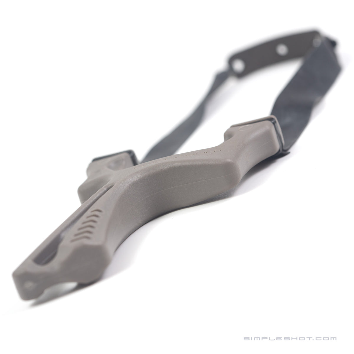 Gray Torque X slingshot lying flat with bands trailing up and to the right